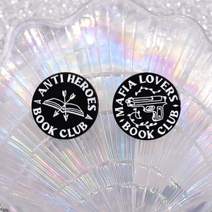 Enamel book club pin set with anti-hero and mafia lover designs on iridescent tray