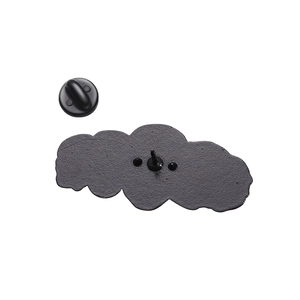 Close-up of matte black alloy brooch back with sandblasted texture and rubber clutch