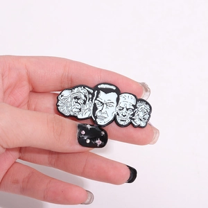 Classic horror movie character enamel pins set featuring four iconic monster head portraits