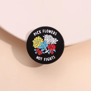 Cartoon enamel pin with colorful flowers and 'PICK FLOWERS NOT FIGHTS' slogan text