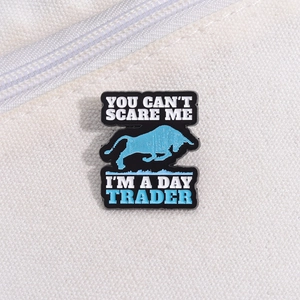 Detail of enamel pin with bull silhouette and Day Trader quote on white canvas