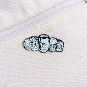 Detail of horror monster enamel pin featuring Frankenstein on a white canvas bag