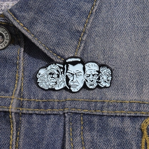 Classic horror character enamel pins set on a blue denim jacket lapel as creative accessories