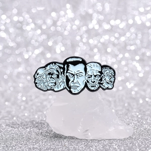 Punk style enamel horror character pins set displayed on a crystal decorative base