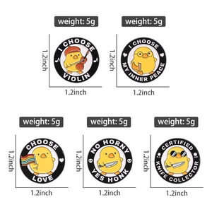 Detailed view of yellow cartoon chick enamel pins showing various creative musical designs