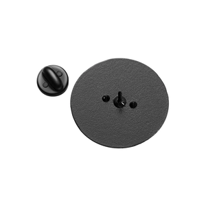 Detail view of the black matte metal badge back with rubber clutch pin backing