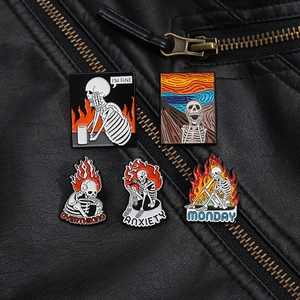 Close-up of five punk skull enamel pins on a black leather jacket background