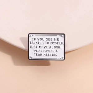 Creative white enamel pin with geometric rectangle design and humorous quote