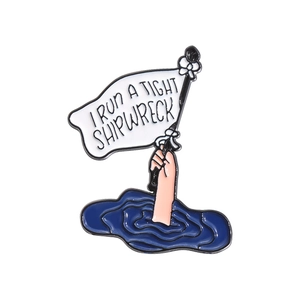 I RUN A TIGHT SHIPWRECK enamel pin featuring a hand holding a flag above sea waves