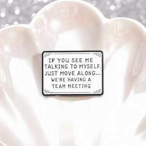 Minimalist enamel pin featuring humorous quote in a pearl-style display dish