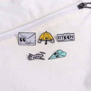 5pcs cartoon enamel pin set with envelope and airplane designs on a white canvas bag