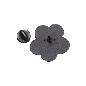 Detail of the black flower brooch back with rubber pin clutch on white background
