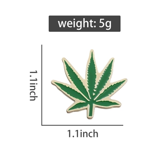 Detail of green maple leaf brooch with gold edges showing dimensions 1.1 inch and 5g weight