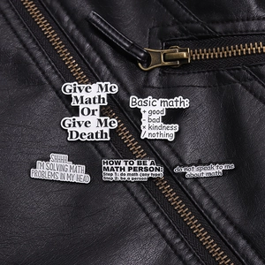 Set of five mathematical themed enamel pins styled on a black leather biker jacket