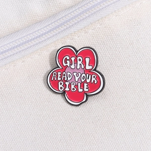 Creative red enamel flower brooch with Girl Read Your Bible text on white canvas