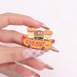 Cartoon burger fries and cola enamel pin set on yellow skateboard with Live Fast text