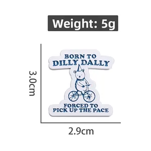 Detail showing cartoon bear riding a bike enamel pin dimensions 3.0cm x 2.9cm and 5g weight