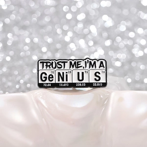 Black and white chemical element enamel brooch pin with Trust Me I'm A Genius slogan