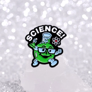 Cartoon science enamel pin featuring a round green character with a flask and atoms