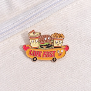 Macro shot of cartoon fast food pins with Live Fast text on a hot dog skateboard