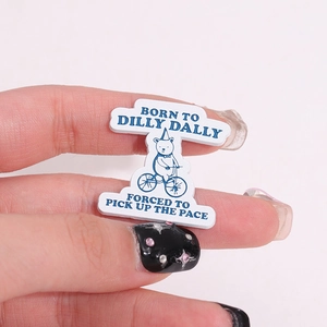 Cartoon cycling bear enamel pin with funny quote on a minimalist pink background