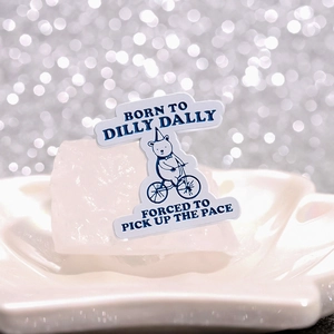 Creative enamel pin of a bear on a bike with Born to Dilly Dally typography