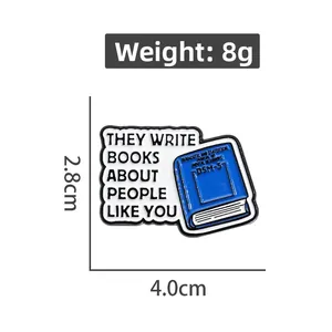 Detail showing blue DSM-5 book enamel pin dimensions 4.0cm x 2.8cm and 8g weight