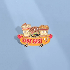 Cartoon fast food enamel pin featuring burger, soda, and fries on a hot dog skateboard