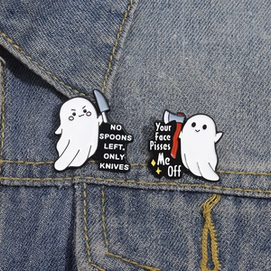 Funny ghost enamel pins with knives design on dark denim background set of two
