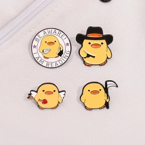 Set of four cute yellow duck enamel pins with humorous reading and cowboy themes