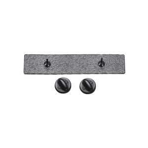 Detail view of rectangular metal pin back with dual needles and rubber butterfly clasps