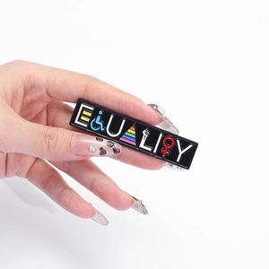 Equality enamel pin badge featuring social diversity symbols on a black metal base