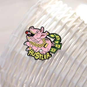 Pink cartoon pig enamel pin with Hustler text and dollar bills for hip hop fans