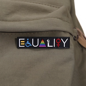 Rainbow Equality enamel pin badge on green canvas bag for clothing and accessories