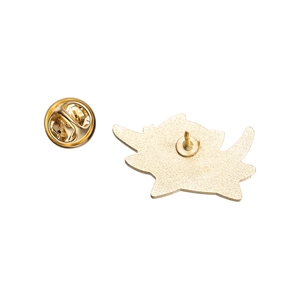 Detail of the golden alloy butterfly clutch and textured pin back for secure fastening