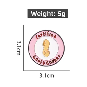 Detail shot of a 3.1cm pink enamel peanut pin badge with Certified Goofy Goober text