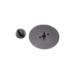 Close-up of circular metal badge back with rubber clutch and sharp pin attachment