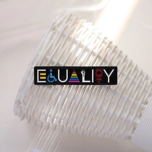 Equality metal enamel pin with rainbow symbols and social justice icons on white mesh