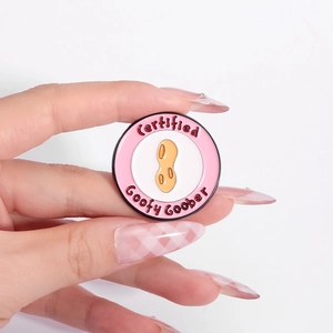 Cartoon peanut enamel medal pin with Certified Goofy Goober text in pink and white