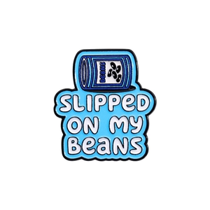 Detail view of enamel bean can pin with Slipped On My Beans text and blue finish