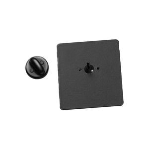 Detail of matte black alloy badge pin back and square metal base on white background