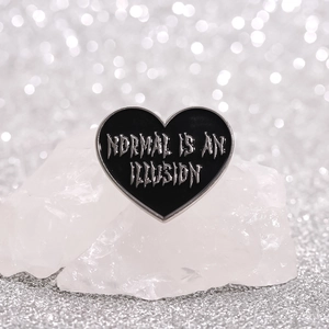 Black heart enamel brooch with Normal Is An Illusion text on white crystal stones