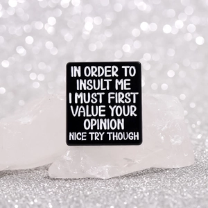 Funny black rectangular enamel brooch with white text on a silver glitter background