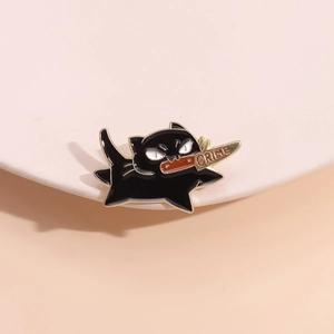 Funny cartoon black cat enamel pin holding a gold knife with crime text engraving