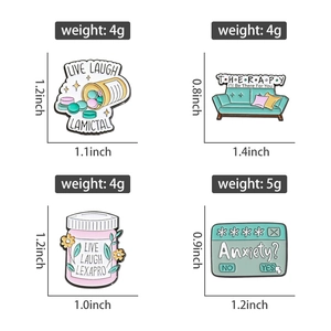 Detailed view of four mental health enamel pins with medicine bottle and therapy couch designs