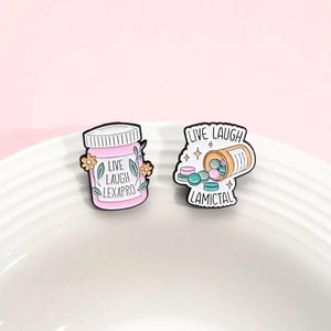 Enamel badges with medication bottle designs featuring Live Laugh Lexapro and Lamictal