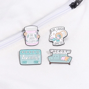 Detail of 4-piece mental health enamel pins including Lexapro and Lamictal pill bottles