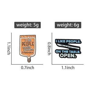 Detailed view of medical enamel pins showing IV drip and scalpel with size dimensions