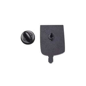 Detail view of the black matte enamel pin back featuring the needle pin and secure rubber clasp