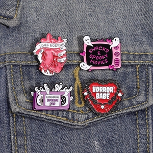 Pink horror TV and ghost enamel pins set on denim jacket, trendy cartoon style pins